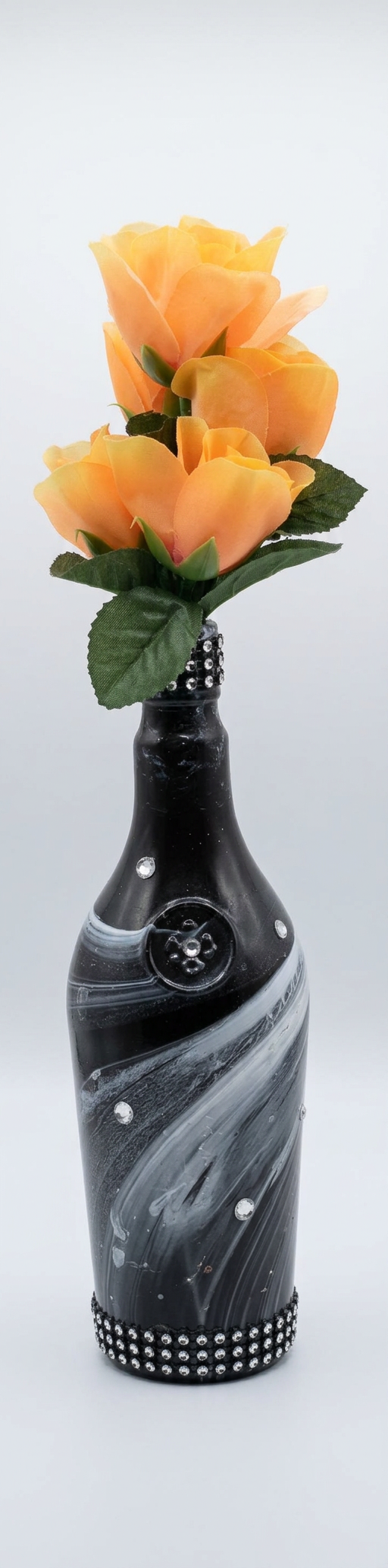 Black and silver marbled bottle vase with orange roses